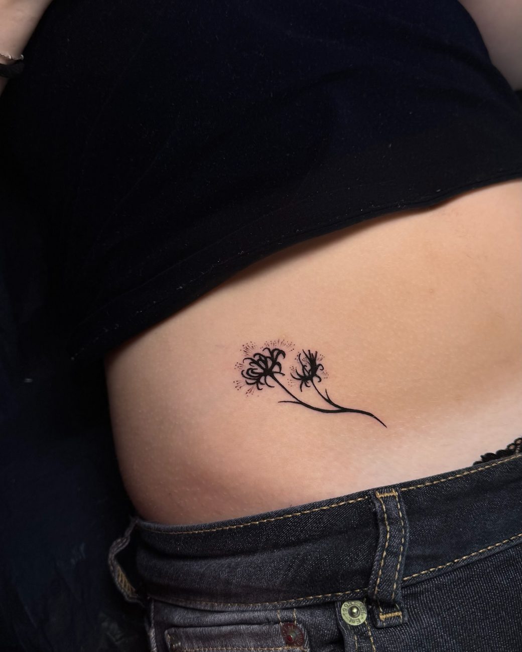 Fine line dandelion tattoo on the ribs